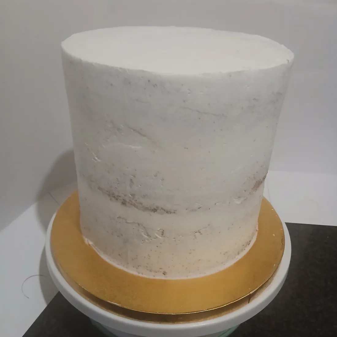 Cake covered with a smooth cream base before decoration